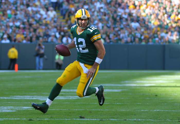 Green Bay Packers quarterback Aaron Rodgers runs with the football.
